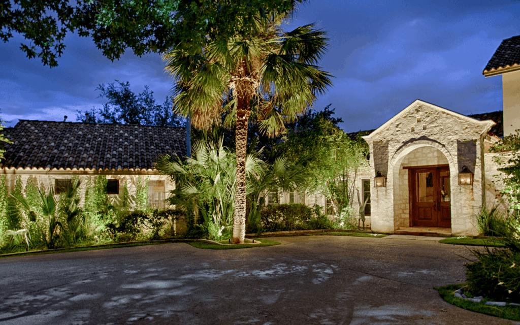 landscape lighting on palm trees and home by The Perfect Light