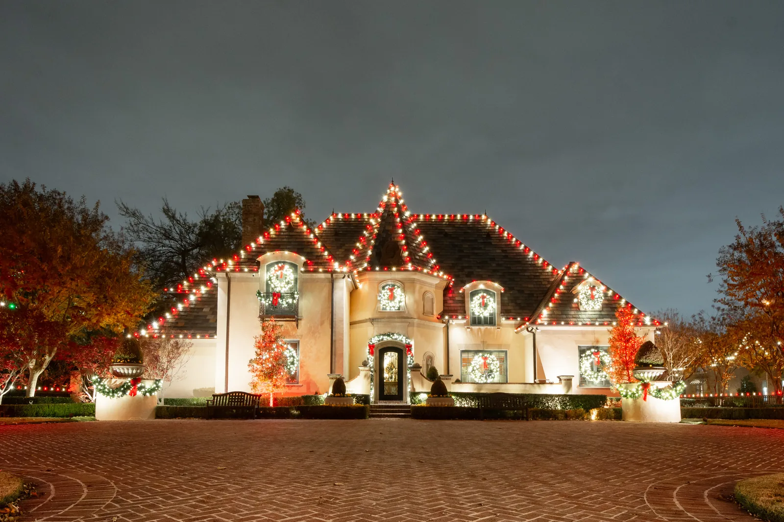 Chateau-style home in the Woodland area with roofline lighting outlining every gable and turret, a $6,000 Christmas lighting installation by The Perfect Light
