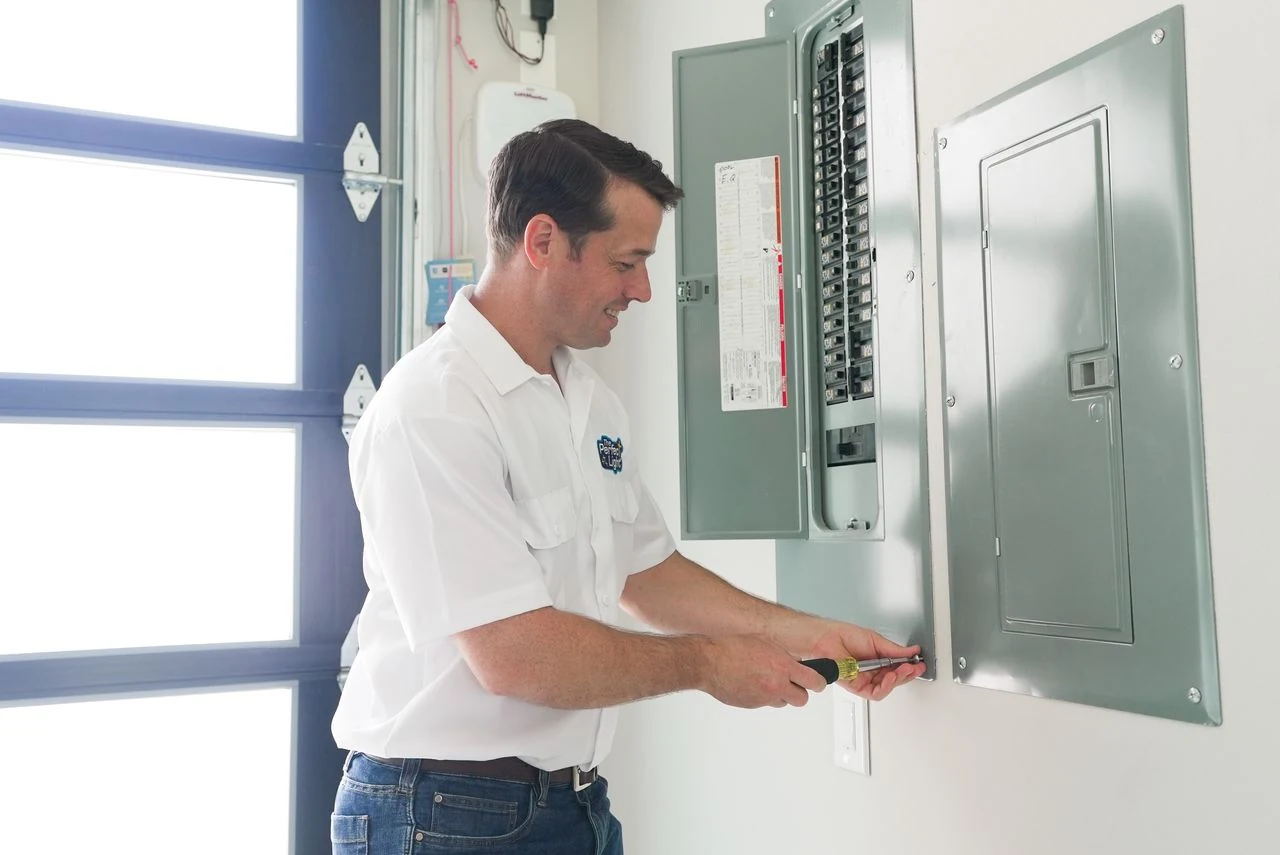 The Perfect Light electrician inspecting a home's electrical panel in Austin.