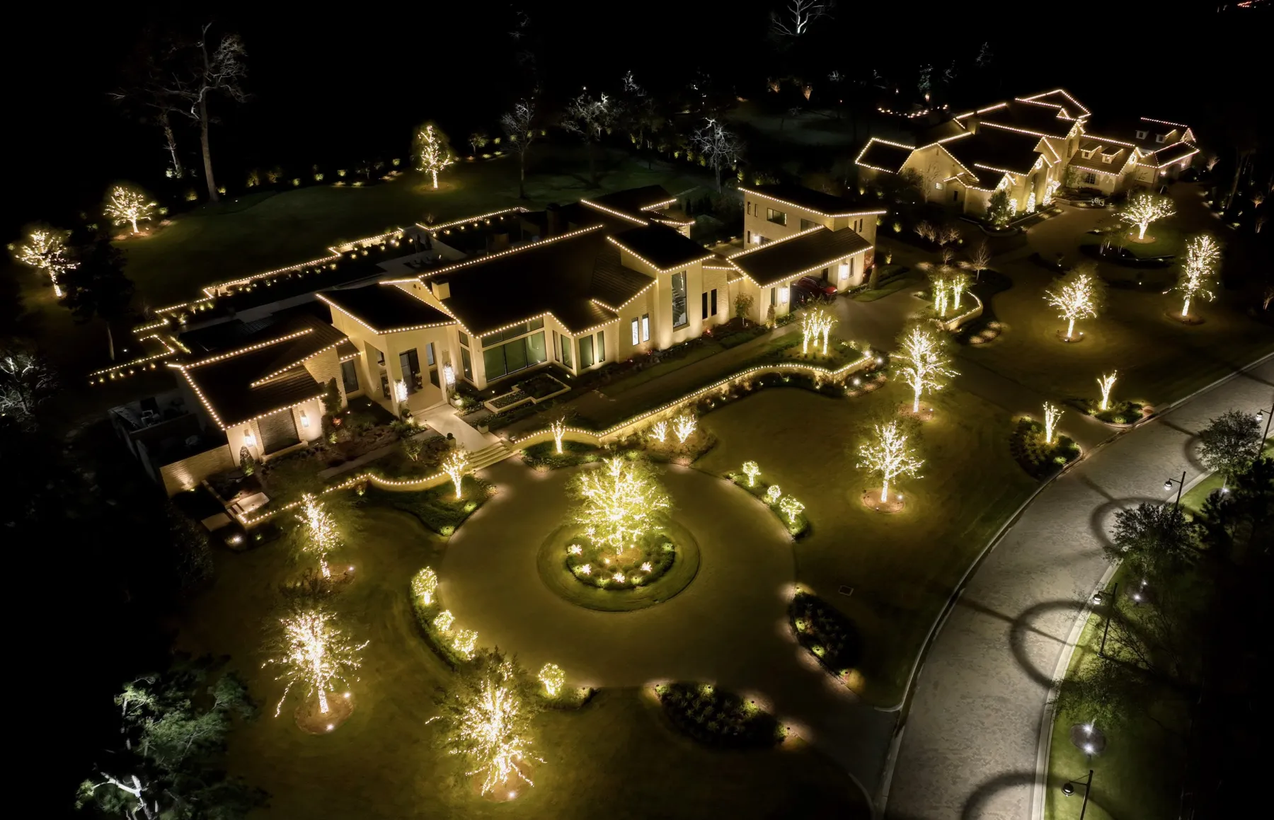 Aerial view of a fully lit Texas estate Christmas lighting display