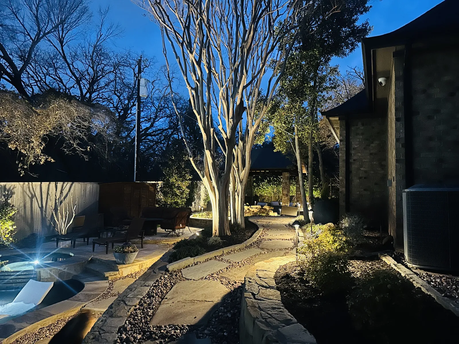 Landscape lighting accenting a Texas home at night