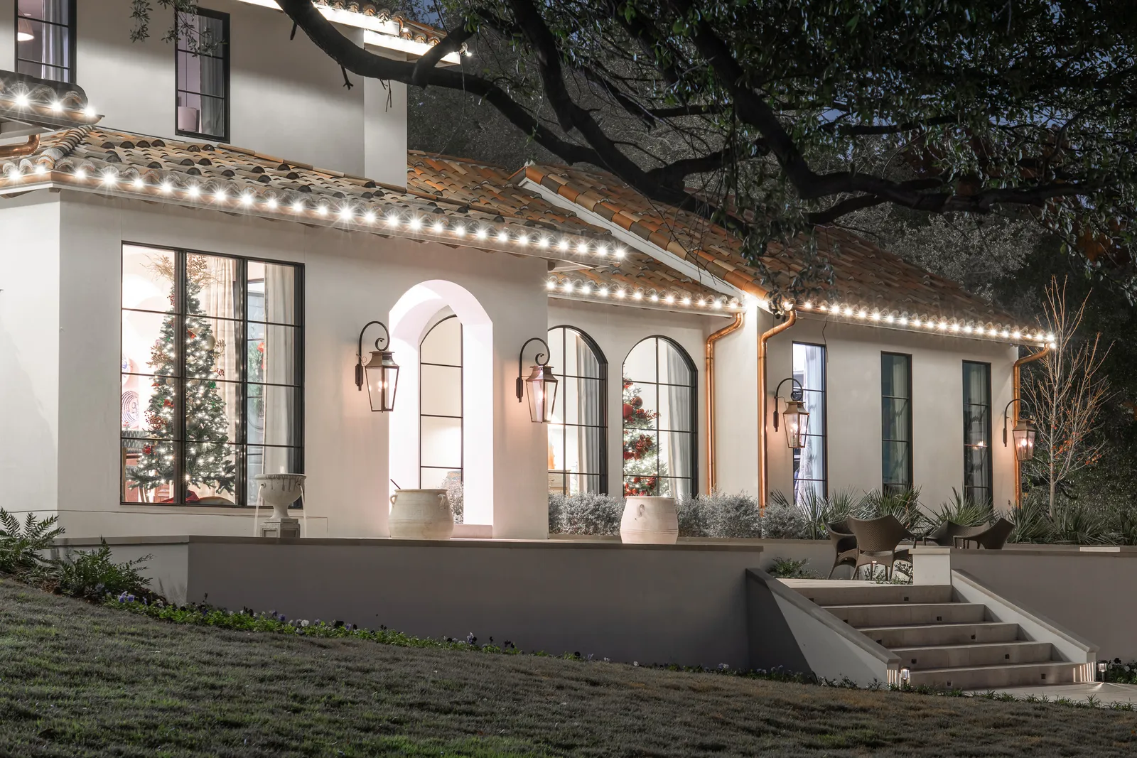Warm-white holiday lighting across a front porch
