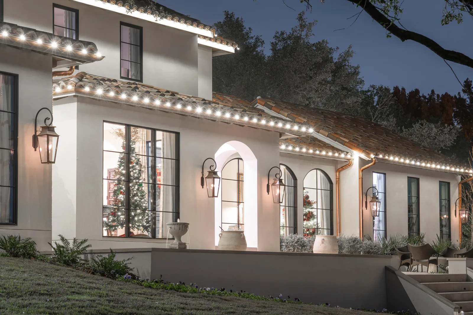 The Perfect Light Christmas lighting illuminating a Texas home at night