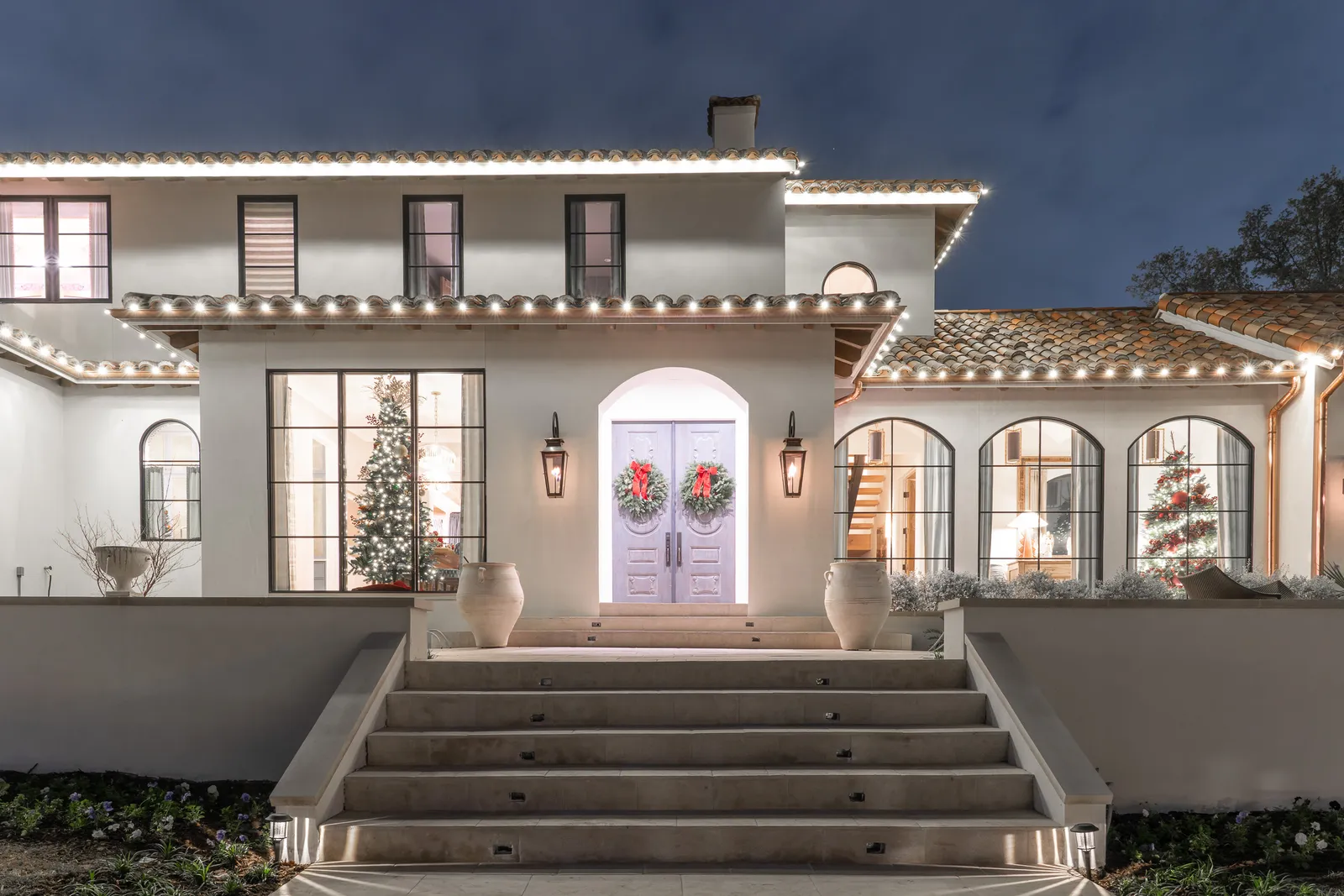 The Perfect Light Christmas lighting illuminating a Texas home at night