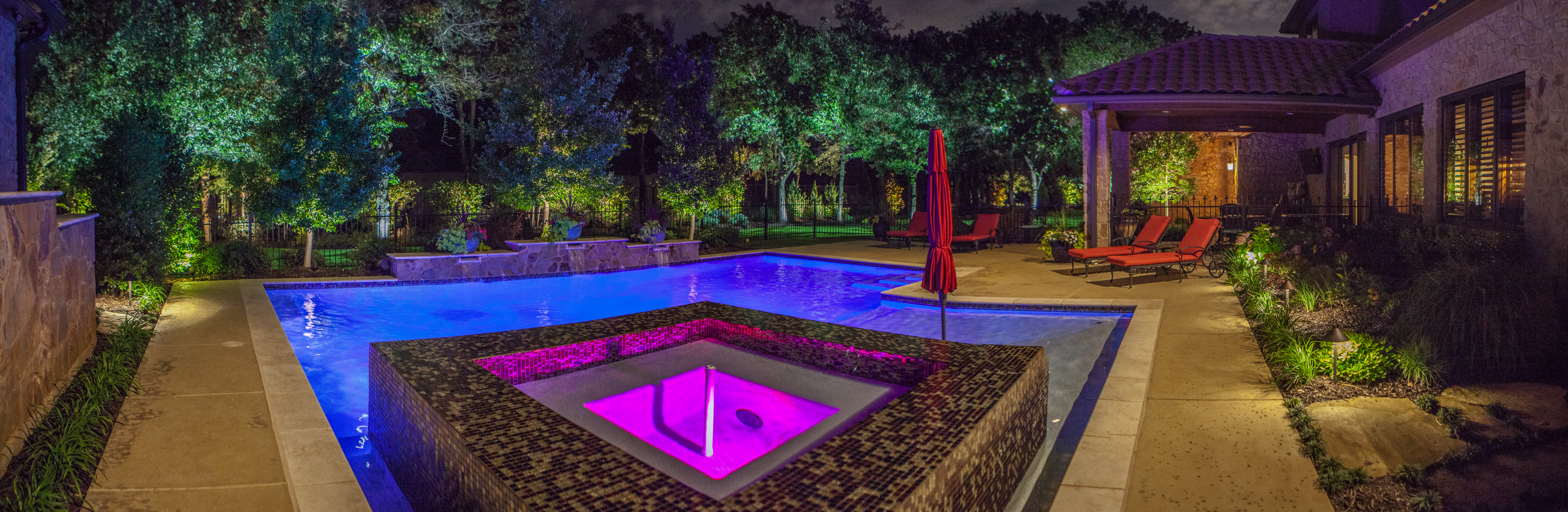 backyard patio with pool and landscaping lights by The Perfect Light